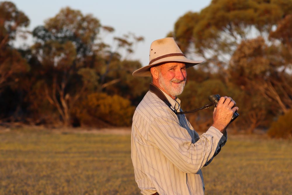 Man in the Mallee conservation area with binoculars
