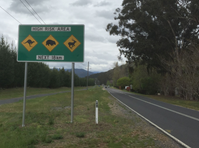 Photo of a sign on the roadside with a warning of kangaroos, wombats and deer in the area.
