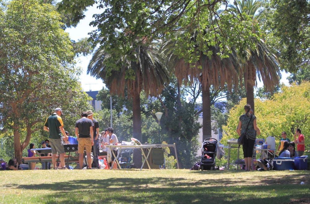 People in casual dress enjoying a picnic in a park
