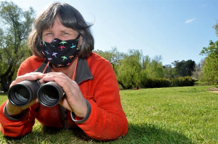 Lady with binoculars looking out for birds