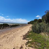 Photo showing Corinella foreshore with sea, sand and land