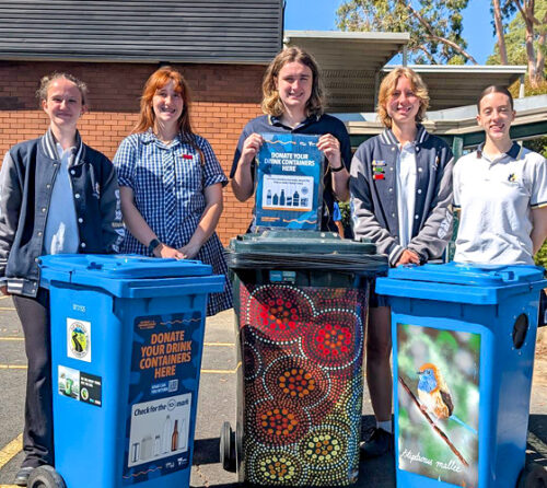 Students pictured in front of bins