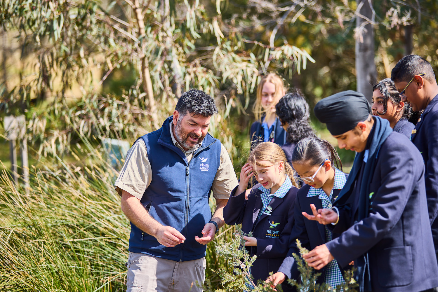 Aitken College's Sustainability Coordinator Dwayne Ganci engaging with students outdoors