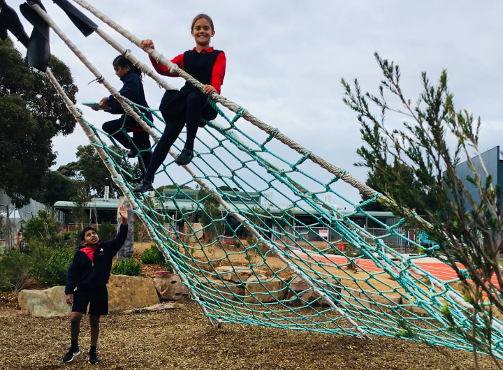 St Louis de Montfort's Primary School students playing on playground equipment