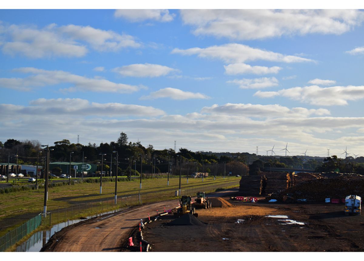 image of construction work with wind turbines in the background